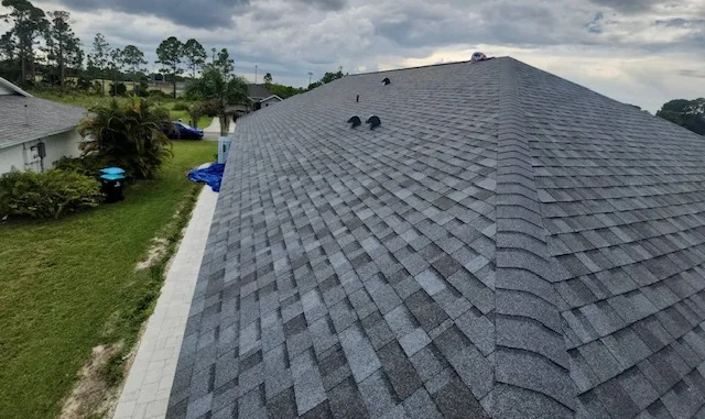 Roofing installation featuring asphalt shingles on a residential building in Palm Bay, showcasing quality craftsmanship and attention to detail.